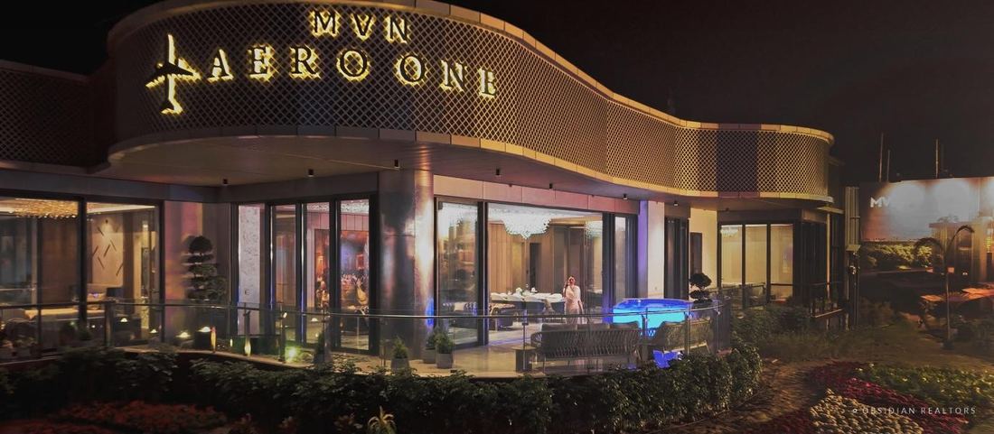 Night render of the arrival court and lit facade at MVN Aero One, Sector 37D, Dwarka Expressway, Gurugram